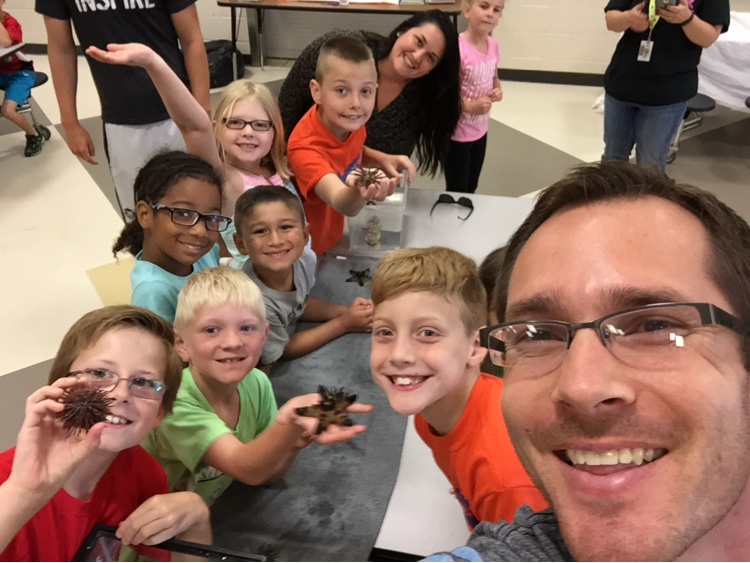 Ben Wehr teaching with an aquarium in a classroom