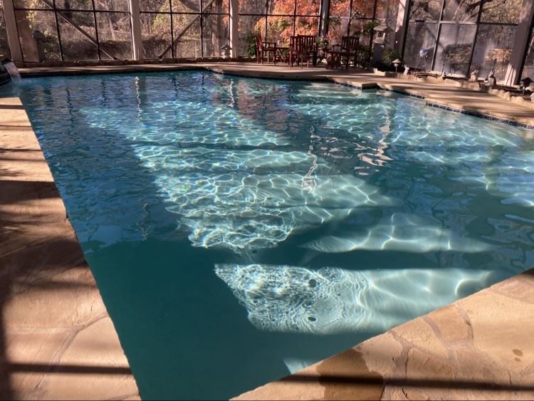 Screened indoor swimming pool with crystal-clear water